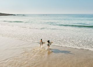 Couple enjoying a morning surf, Birubi Beach, Port Stephens